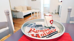 A dining table with a tray containing a glass of milk and a plate with 'Romantic Holiday' text.