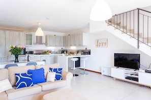 A modern apartment with a living room, kitchen, and a staircase. - Family friendly Italian Lakes villa rental (Dumenza)