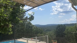 A pool area with a stone patio, a pergola, and a view of the surrounding landscape. - SUPERB SECLUDED VILLA WITH STUNNING VIEWS AND HEATED SWIMMING POOL 
 (Saint-Antonin-Du-Var)