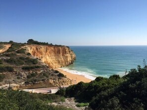 A coastal landscape with a cliff, beach, and a small building. - Casa Vitor is a hidden Gem, this lovely moorish villa well appointed (Carvoeiro Lagoa)