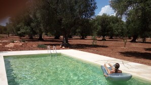 A rectangular pool with clear water, surrounded by trees. - "Trulli Monte Madre 2" with Private Swimming Pool (San Vito dei Normanni)