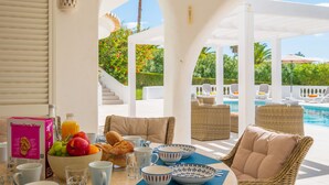 A breakfast setup with a fruit bowl, croissants, and a Powering You cereal box on a table with white and blue patterned bowls and cups. - Fabulous spacious villa [57] (Lagos)