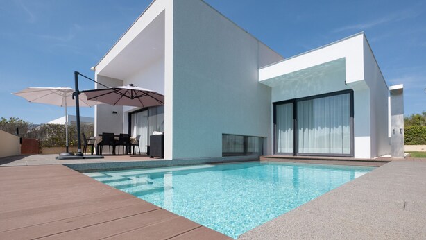 A modern house with a swimming pool, outdoor furniture, and a patio area. - Modern accessible villa [17] (Luz)