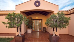 A building with a beige facade, a circular window, and a tiled entrance. - Luxury Villa near to Mijas Pueblo that sleeps 14. With Large Private Heated Pool (Mijas)