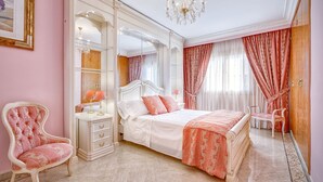 A bedroom with a large bed, a vanity with a mirror, a chair, and a chandelier. - Beautiful villa with private pool excelent for families. Aircond and wifi available - Free Wifi (Llucmajor)