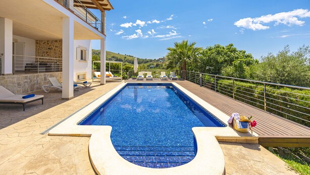 A swimming pool with lounge chairs and a view of the surrounding landscape. - Villa Heura (Alcúdia)