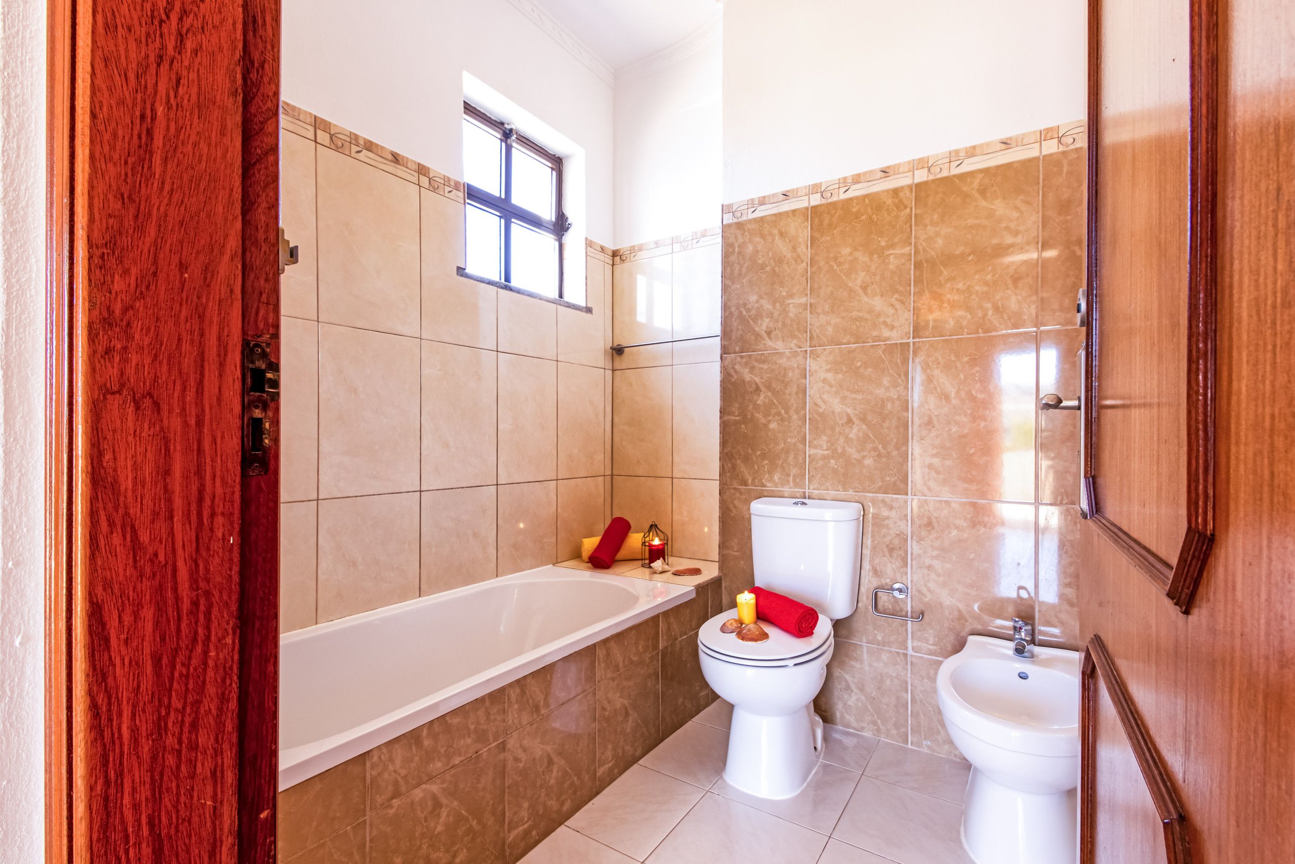 A bathroom with a bathtub, toilet, and bidet.