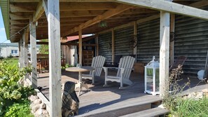 Relax on the deck with a round table and two Adirondack chairs.