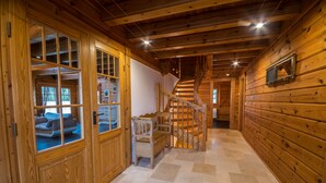 A wooden interior with a staircase, wooden walls, and a tiled floor. - Comfortable wooden house in the heart of Saxon Switzerland above Rathen (Bad Schandau OT Waltersdorf)