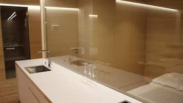 Enjoy a refreshing drink at the spacious vanity with sink and mirror.