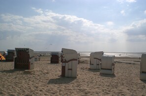 Relax in comfort on the spacious beach with beach chairs facing the sea.