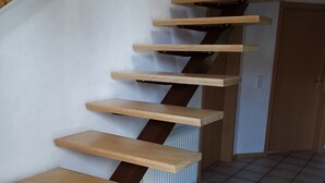 A spiral staircase with wooden steps and metal handrails. - Super idyllic vacation home with privacy to relax, WiFi included. (Jemgum)