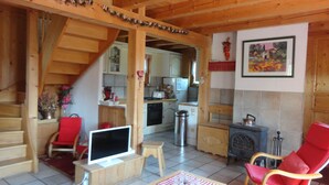 Un interno accogliente in legno con una scala, un angolo cottura e zone relax.