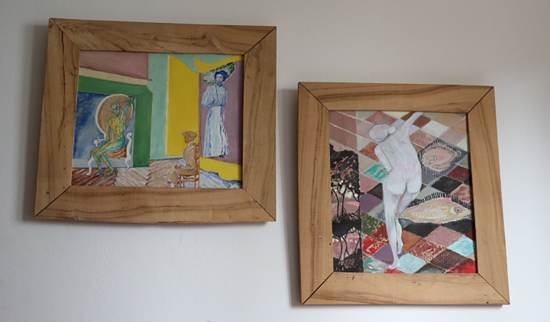 Two framed artworks on a wall.