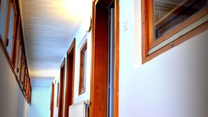 A long, narrow hallway with wooden doors and windows, leading to multiple rooms. - House Limeray, House Kayserberg Vineyard 10 people (Kaysersberg Vignoble)