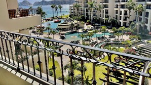 A resort with multiple swimming pools, palm trees, and a view of the ocean and mountains. - Book a spectacular ocean view 5 star resort !  (Cabo San Lucas)