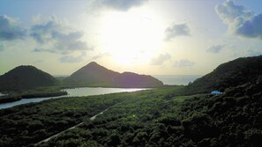 A coastal landscape with a mountain, a body of water, and a road. - HIGH DEMAND. POOL, WALK TO BEACH, PANORAMIC SEA VIEWS, OVERLOOKS JOLLY HARBOUR (Jennings)
