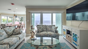 A living room with a sofa, a glass coffee table, and a TV on a white cabinet. - Paradise Bay - 4 Bedrooms [with 2 Master Suites] & 4 Bathrooms - sleeps 10 (Marathon)