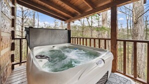A hot tub on a wooden deck with a view of trees. - An Affair to Remember - 1BR/New Hot Tub/New Firepit/Grill/Perfect for 4 (Gatlinburg)