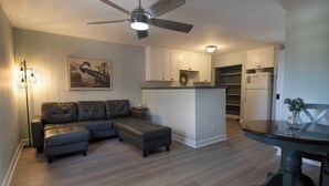A modern kitchen with a built-in island, a dining table, and a ceiling fan. - 1Br/1Ba Close to Beach & Shops- Heron's Nest (Folly Beach)