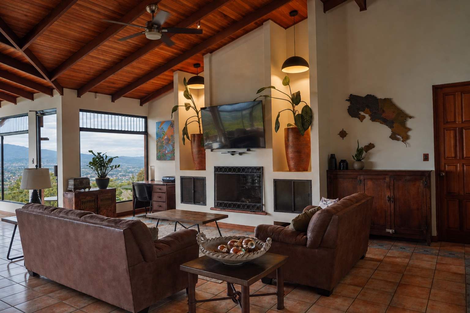 A spacious living room with a fireplace, comfortable seating, and a large television.