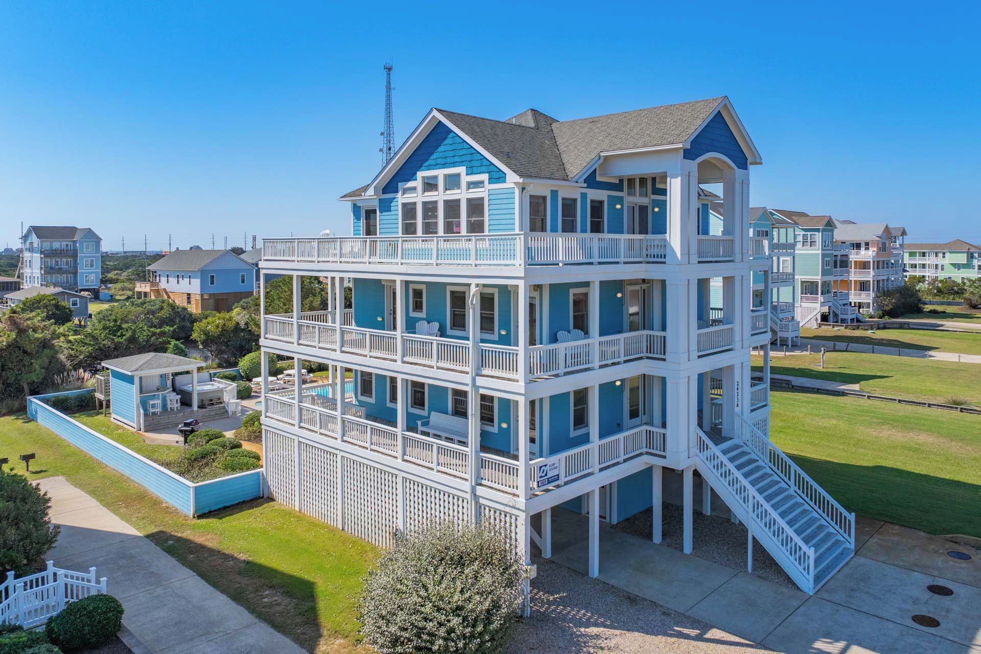A multi-story building with balconies and a pool area.