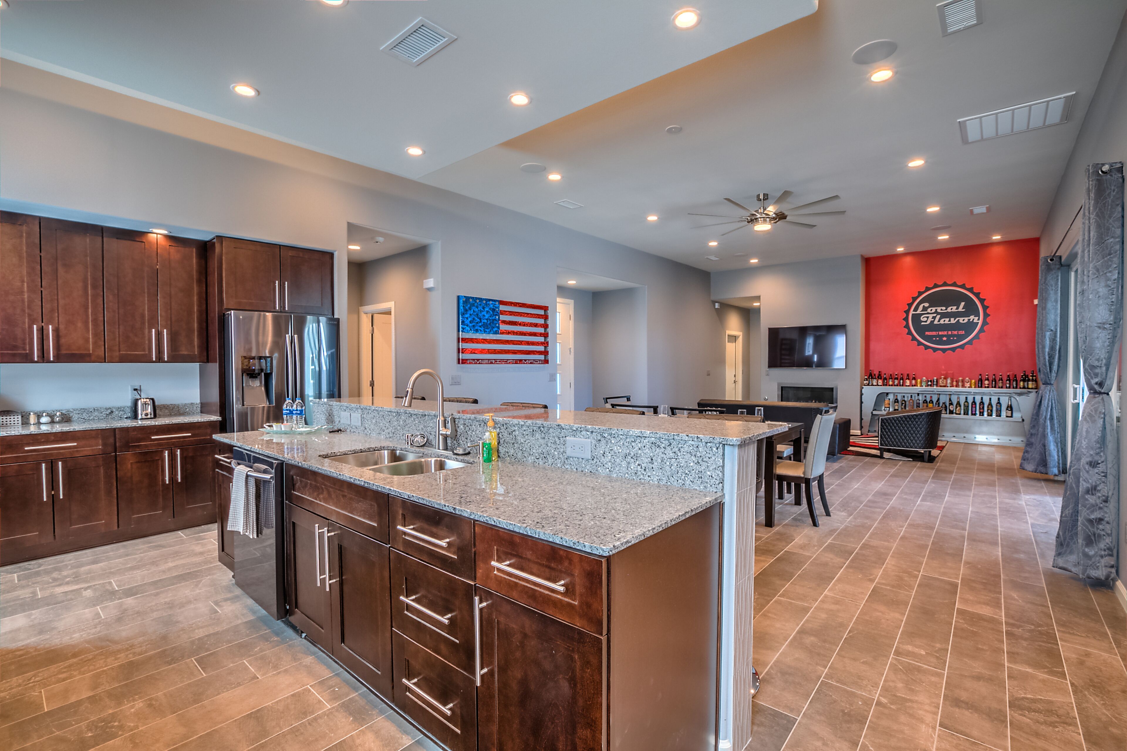 A modern kitchen with granite countertops, stainless steel appliances, and a central island.