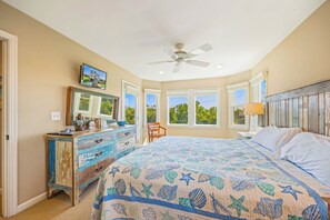 Quarto com cama, penteadeira e ventoinha no teto.