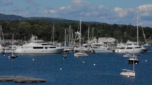 A marina with several yachts docked. -  Unique Marina Side Condo With Great Views And Fun Atmosphere! (Southwest Harbor)