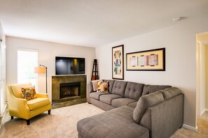 Smart TV, fireplace, books, computer monitors