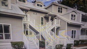 A two-story house with a central staircase and a small porch.