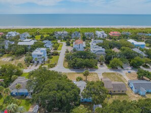 An aerial view of a coastal residential area with houses, roads, and a beach. - Just One Block to BEACH! Cute and comfortable beach home with Screened Porch! (Isle Of Palms)