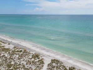 A beach with clear turquoise water and a sandy shore. - How Sweet It Is...Private Island Beach Life (Placida)