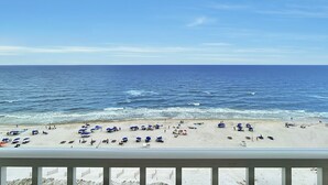 A beach with umbrellas and beachgoers. - Orange Beach Luxury Corner Condo (Orange Beach)