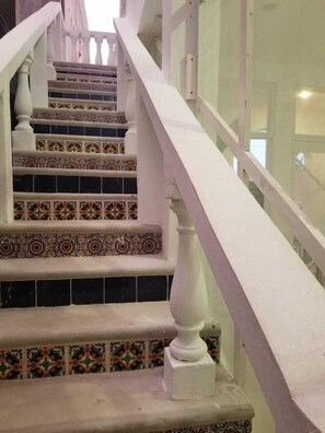 Stunning staircase with a patterned tile design adorns the interior of this property.