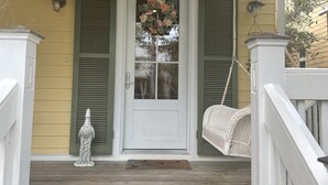 A porch with a white door, green shutters, and a hanging wreath. - RELAX, RENEW, REJUVENATE! (Santa Rosa Beach)