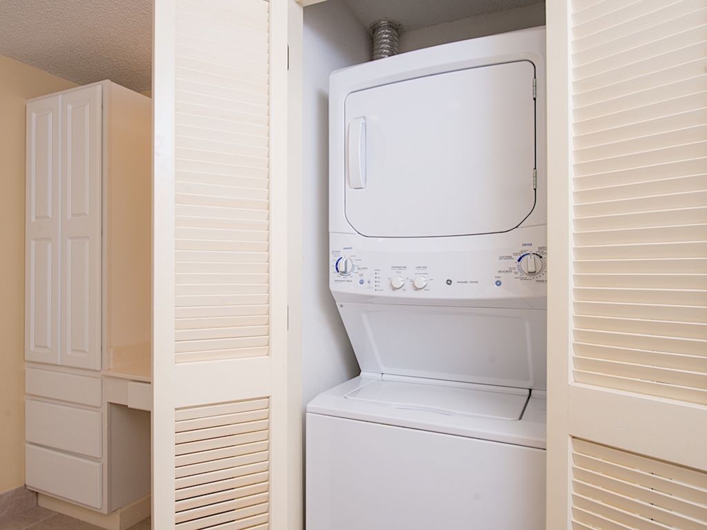 A laundry room with a front-loading washing machine and a dryer.