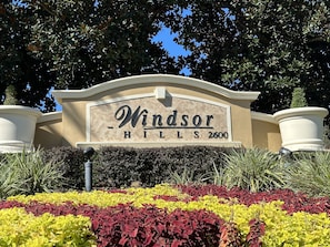 Welcome to Windsor Hills, a well-maintained residential area with clean landscaping and a prominent entrance sign.