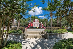 Explore a vibrant park setting surrounded by lush greenery and a playground structure.