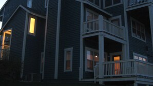 A multi-story building with a balcony on the second floor.