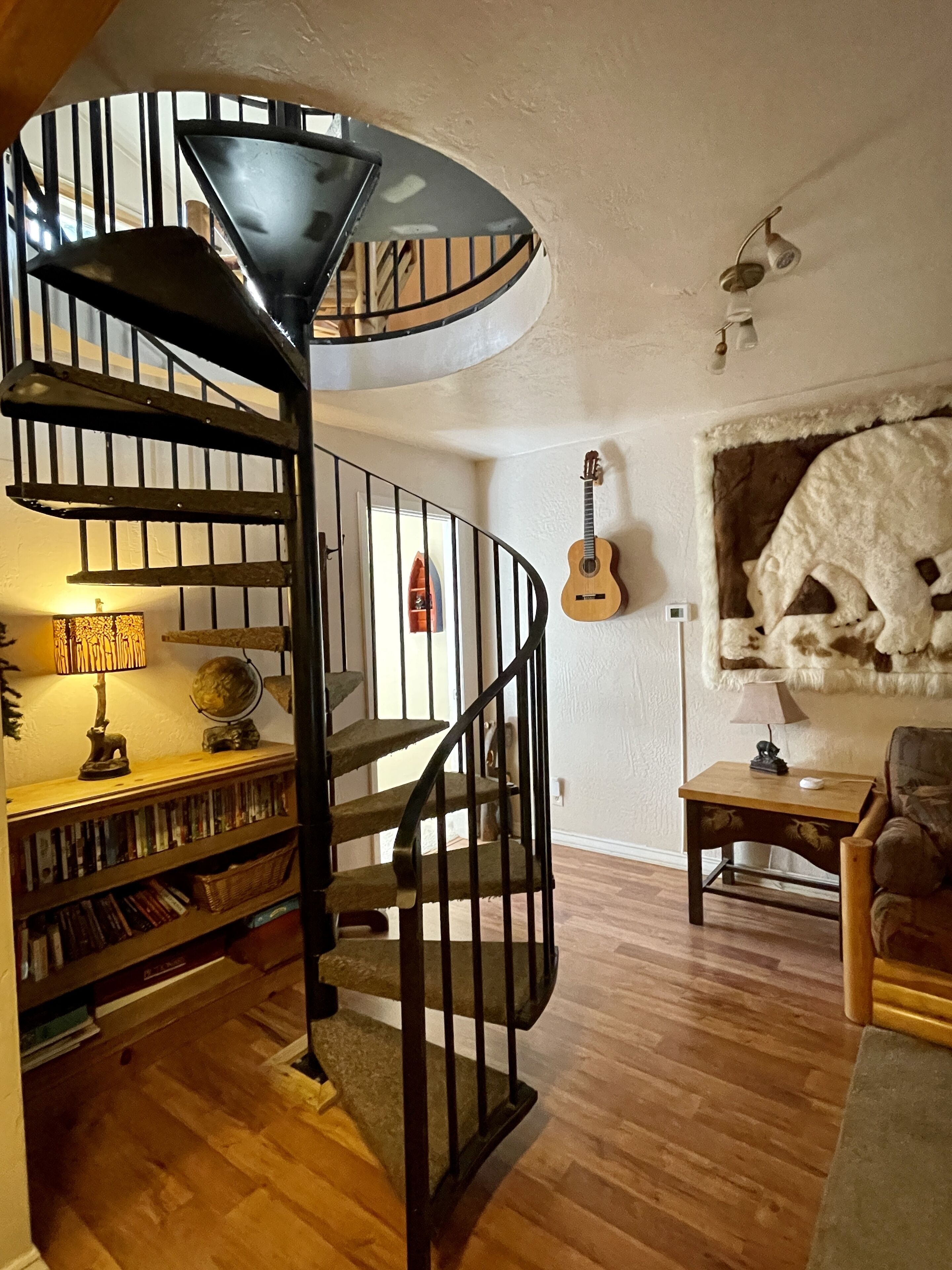 Spiral stairs down to  kids/family area and bedrooms