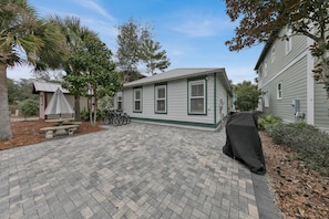 A residential property with a paved patio, a covered barbecue area, and bicycles parked outside. - Barefoot Bungalow-Cozy Retreat, Seacrest 30A Pet Friendly,4 Bikes,6 beach chairs (Rosemary Beach)