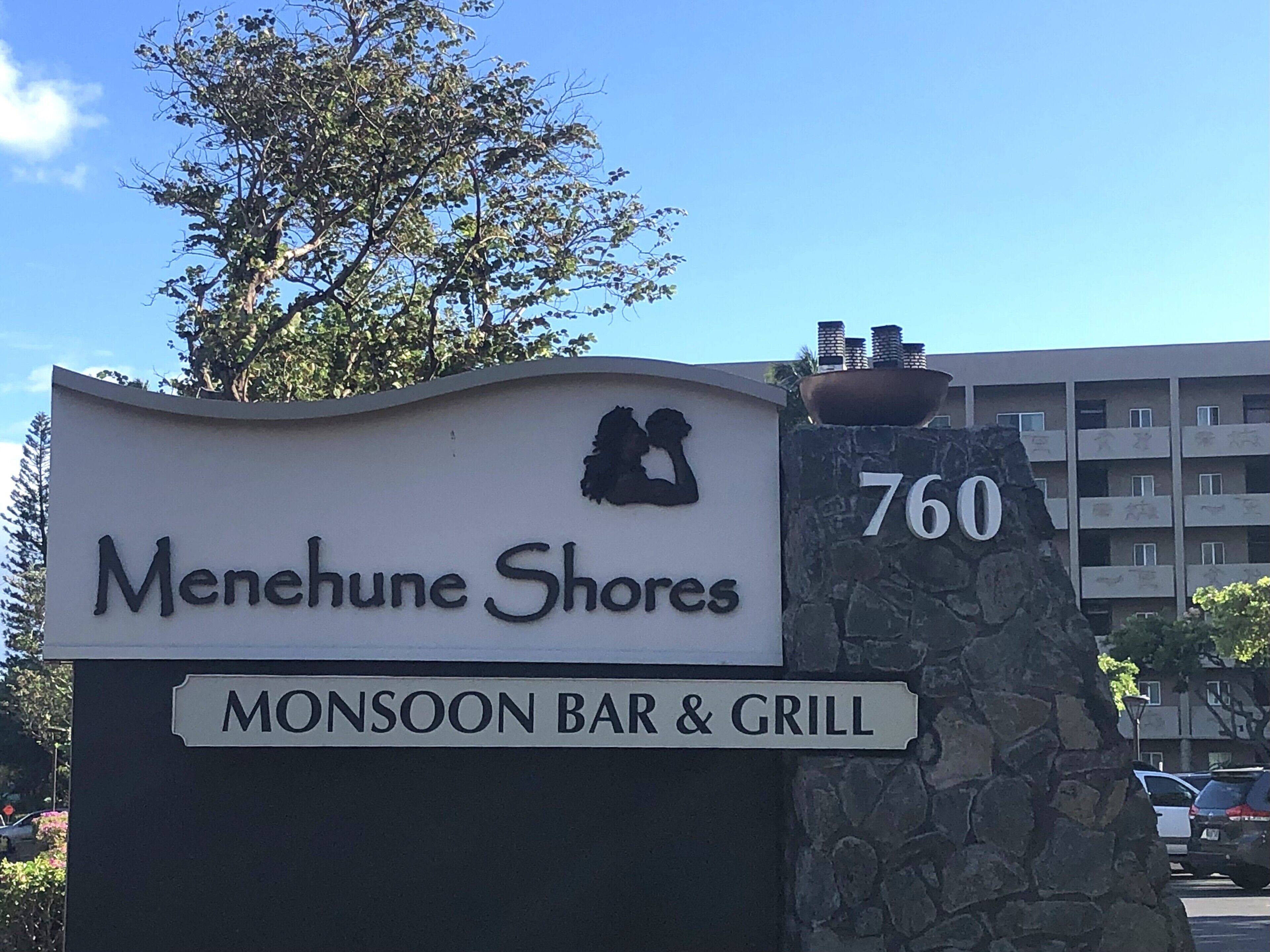 A sign for Menhune Shores with a Monsoon Bar & Grill.
