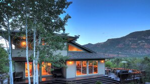 A two-story house with a deck and a mountain view. - Mountain retreat, epic views, hot tub, decks, game room. A/C, Non-smoking. (Durango)
