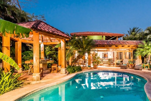 View of pool, grill and outdoor living area.