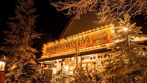 A building with a sign reading "General Mercantile Grocery Deli" at night. - Great Location/100 yd. to lift, Club Member, Walk To Resort & Fire pit!  (Beech Mountain)
