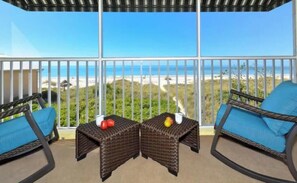 A balcony with wicker furniture and a view of the beach. - Cabana Beach Club - Beachfront Stunning Ocean View *Snow Bird Promo* Winter 2027 (Longboat Key)