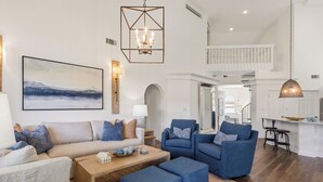 A spacious living room with a sofa, chairs, a coffee table, and a painting on the wall. - Blue Haven, Tivoli, Sandestin, Golf Cart (Miramar Beach)