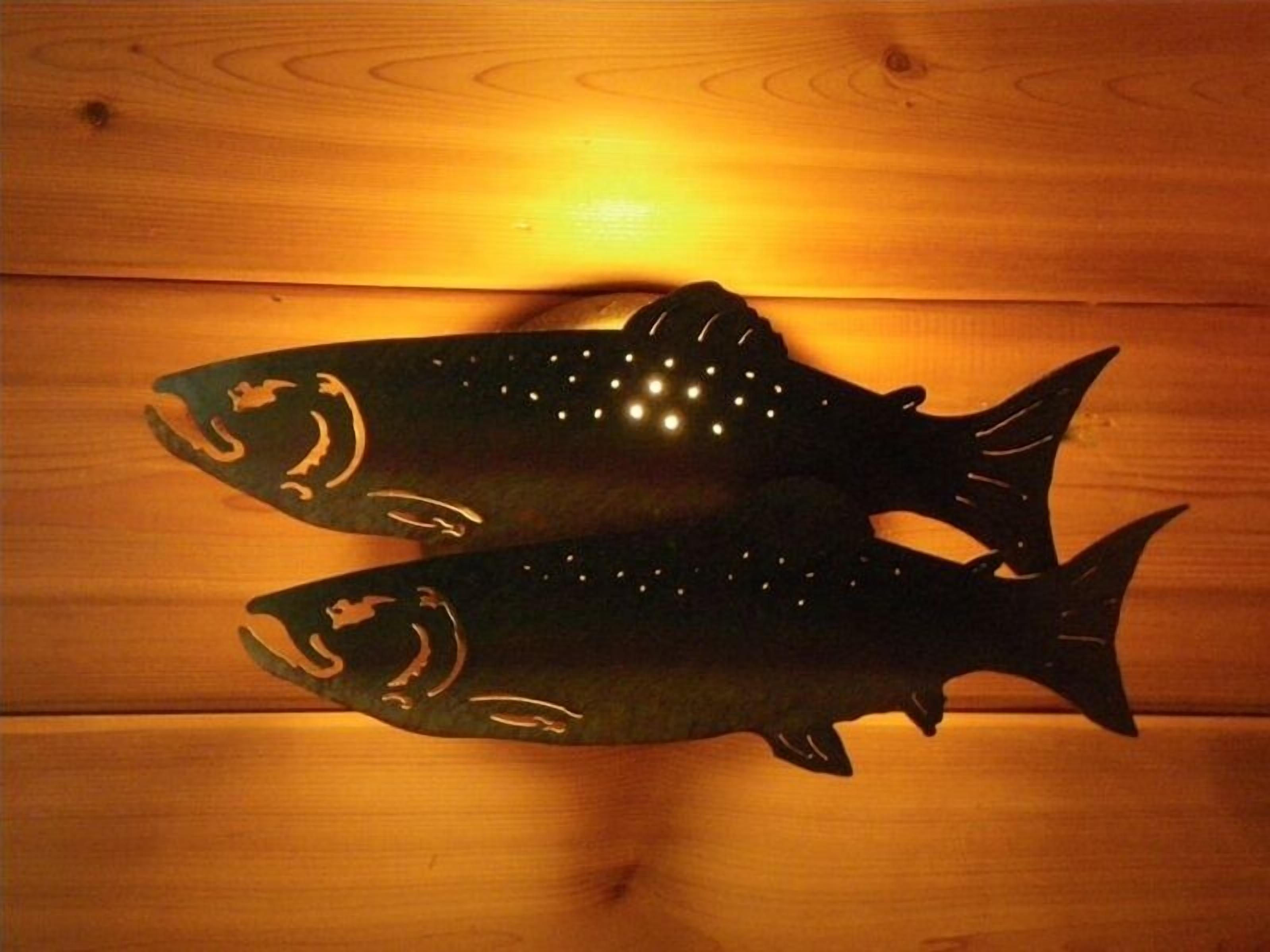 Two fish-shaped decorations on a wooden surface.