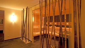 A spa room with a wooden bench, a glass partition, and a bamboo screen. - Hotel Lipprandt (Wasserburg am Bodensee)